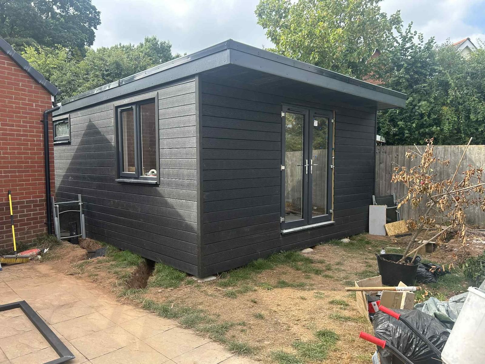 Composite-clad garden room with bi-fold doors — JLG Construction Services