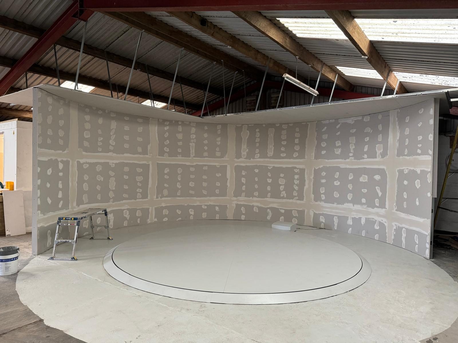 Curved feature wall around the turntable, boarding stage, HM Car Sales, JLG Construction Services