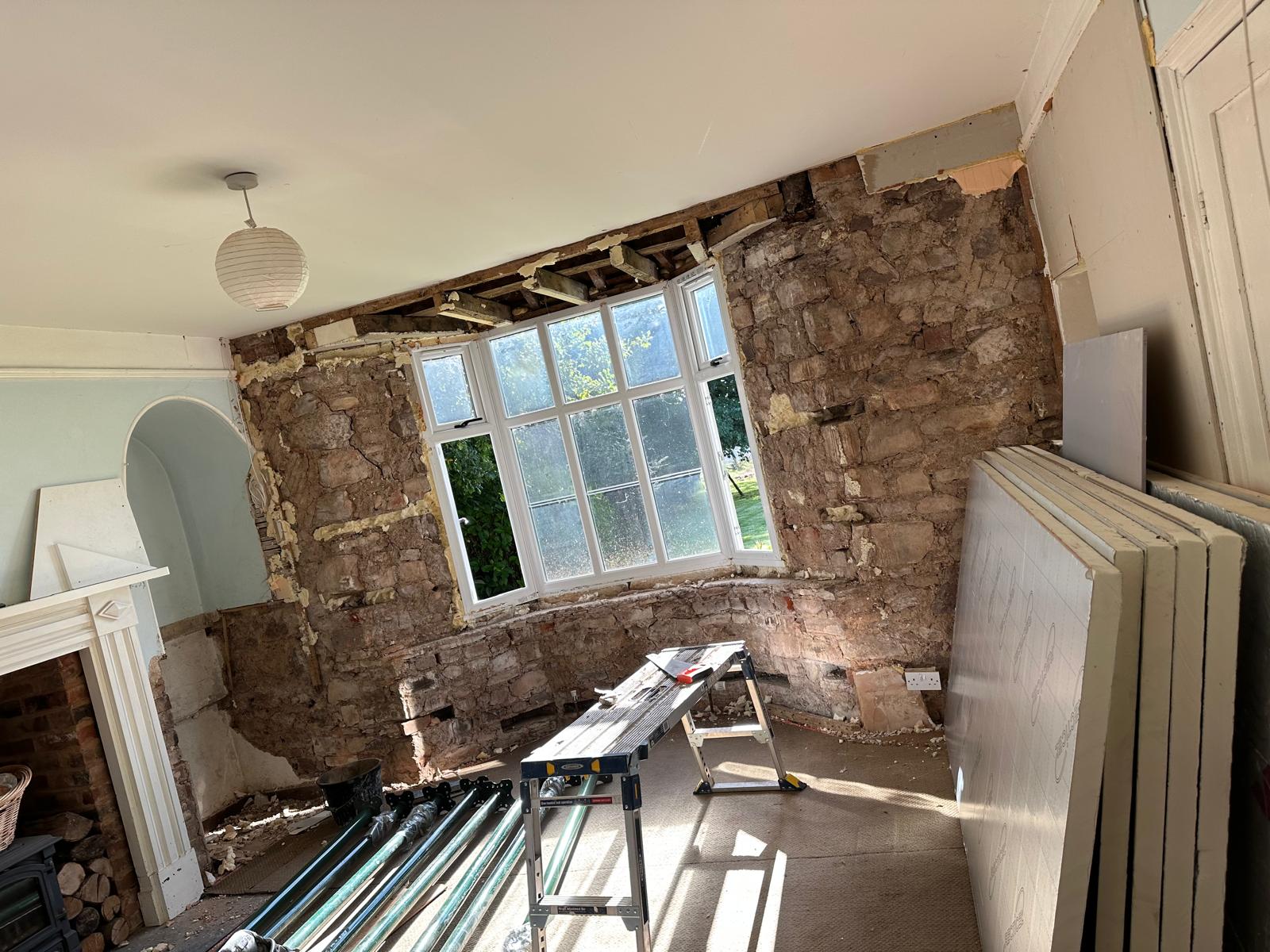 Solid stone walls stripped back, insulation boards on site, Stoodleigh Cottage Renovation, JLG Construction Services