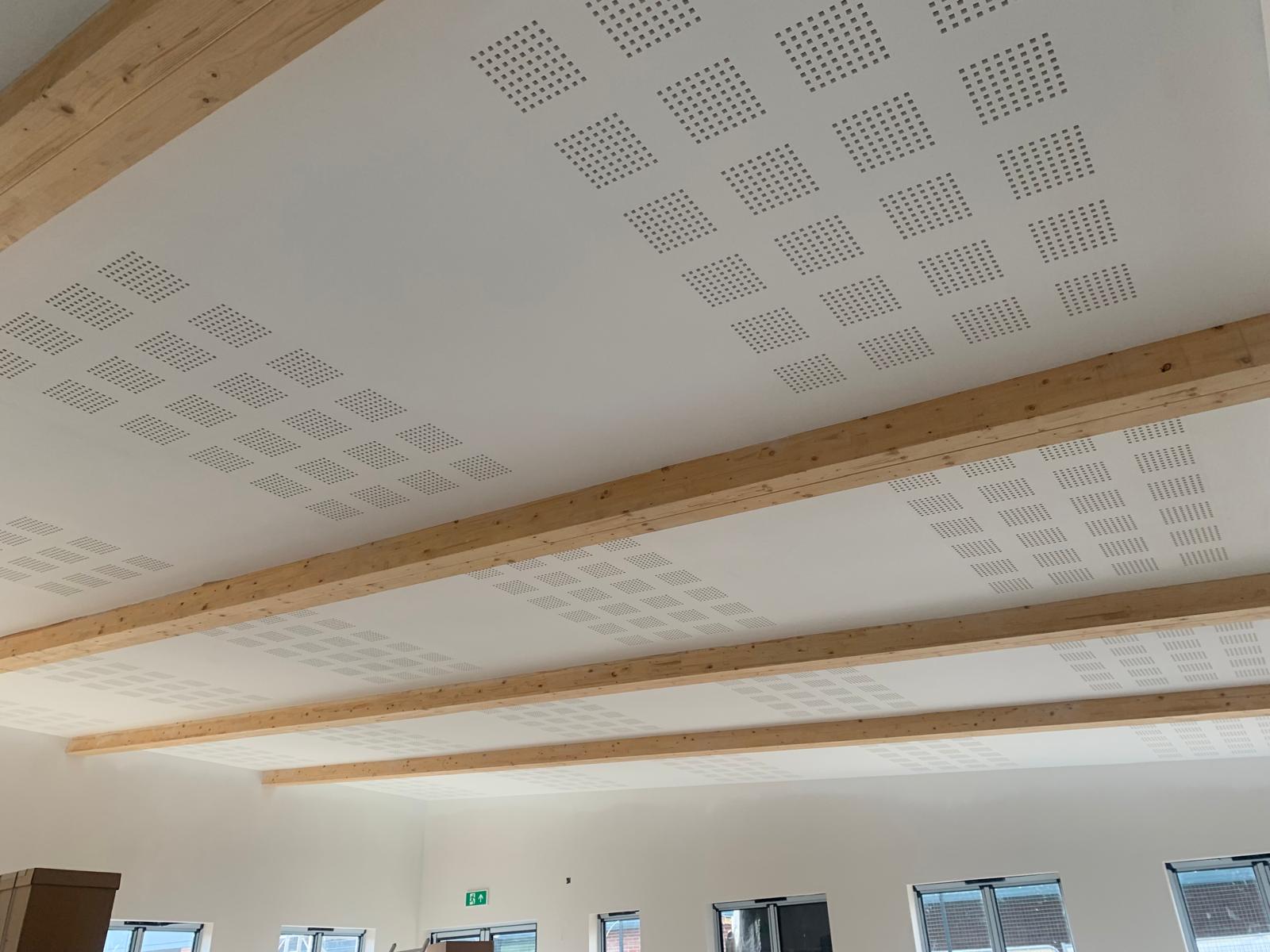 The finished perforated acoustic ceiling between the timber beams, Wimborne School, JLG Construction Services