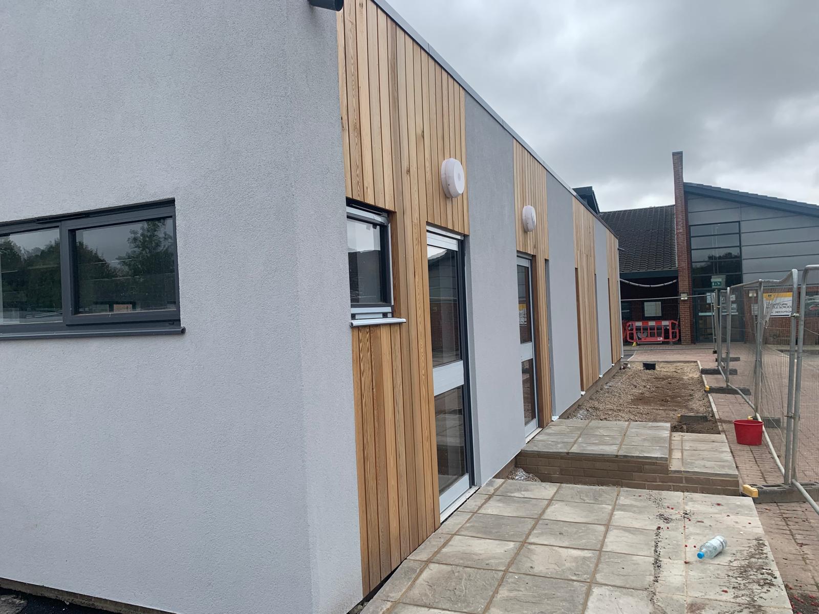 The finished exterior, render and timber cladding, Wimborne School, JLG Construction Services